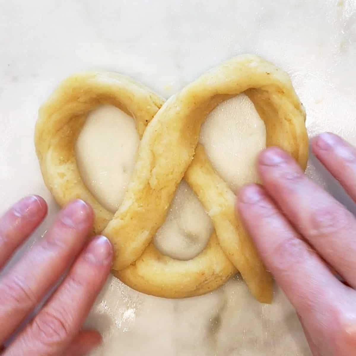 Shaping the dough into pretzels.