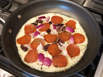 Toppings were added to the pizza.