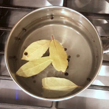 Heating the water-vinegar solution in a small saucepan.