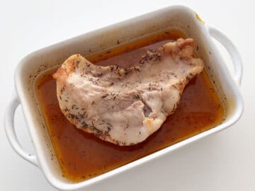 Braised pork jowl in a baking dish.
