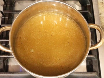 Broth and spices in a saucepan.