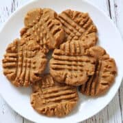 Keto peanut butter cookies are served on a white plate.
