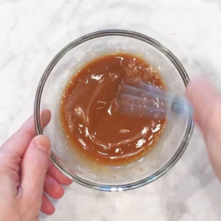 Mixing the sauce in a bowl.