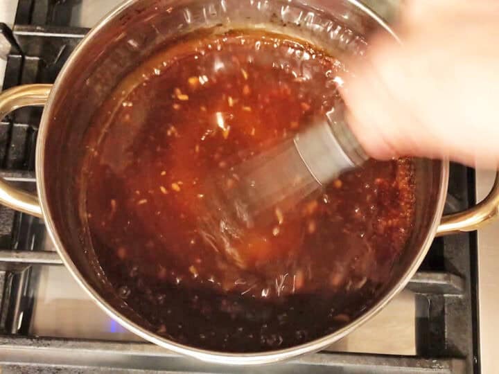 Mixing the teriyaki sauce ingredients in a saucepan.