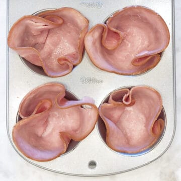 Four muffin cups were lined with ham slices.