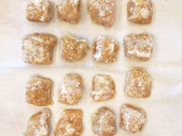 The nuggets are on the baking sheet, ready for the oven.