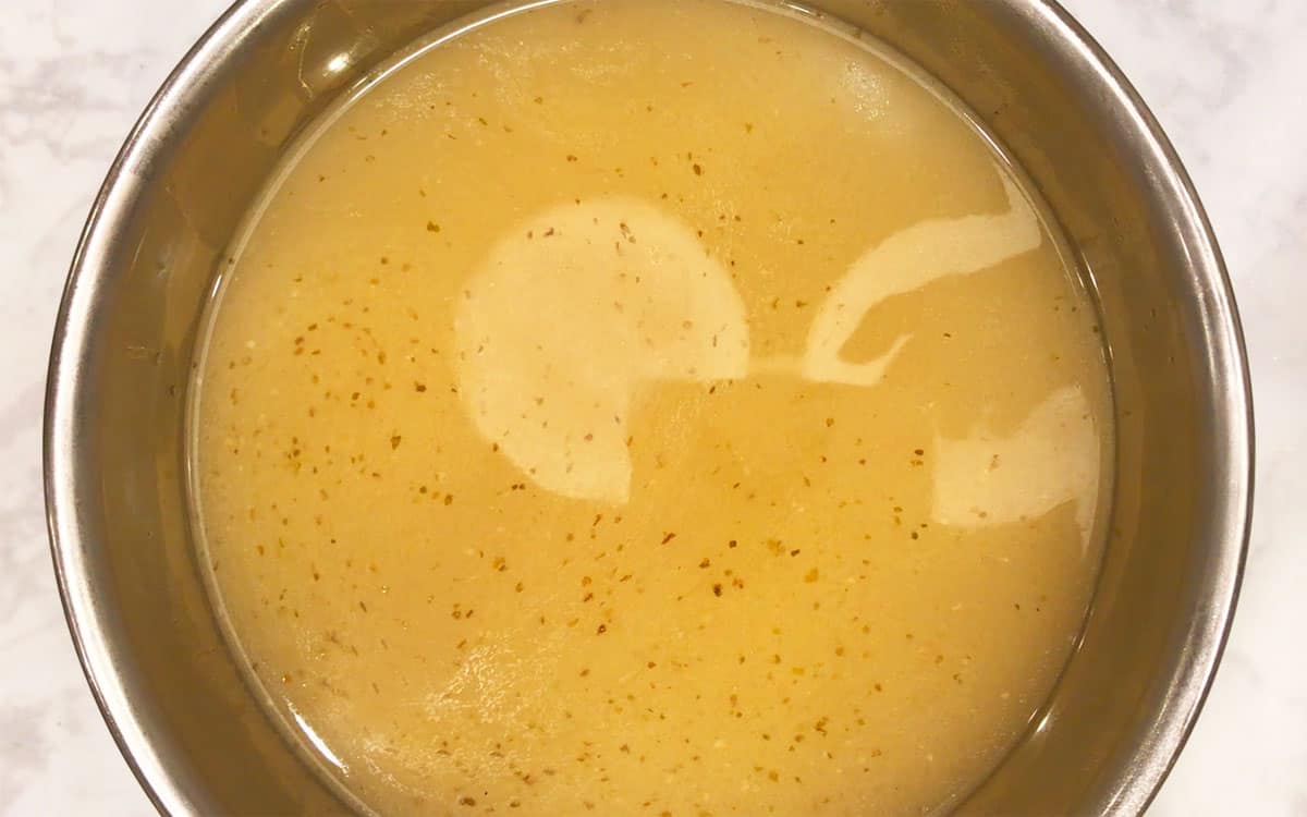 Strained turkey stock in a bowl.