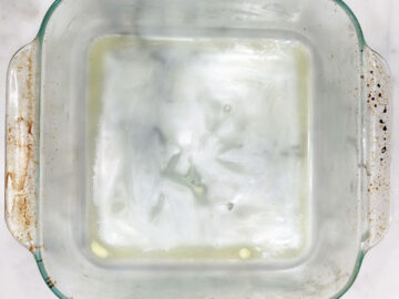 A buttered 8-inch square baking dish.