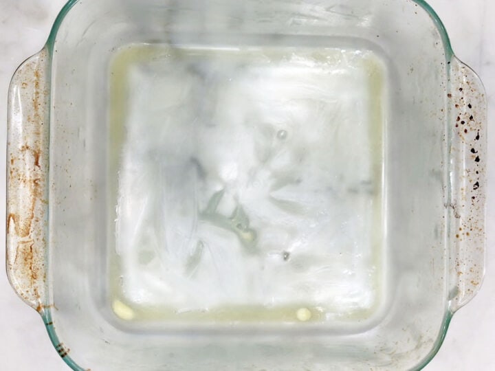 A buttered 8-inch square baking dish.