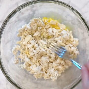 Mixing the crab meat into the egg mixture.