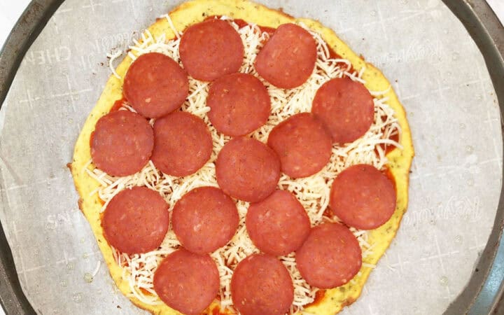 The toppings were added to the pizza.