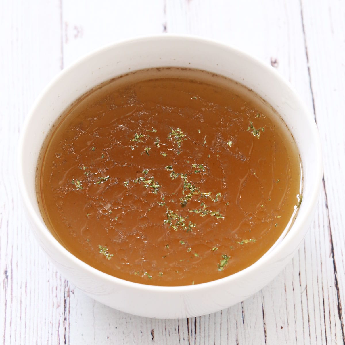 Beef tongue broth in a white bowl.