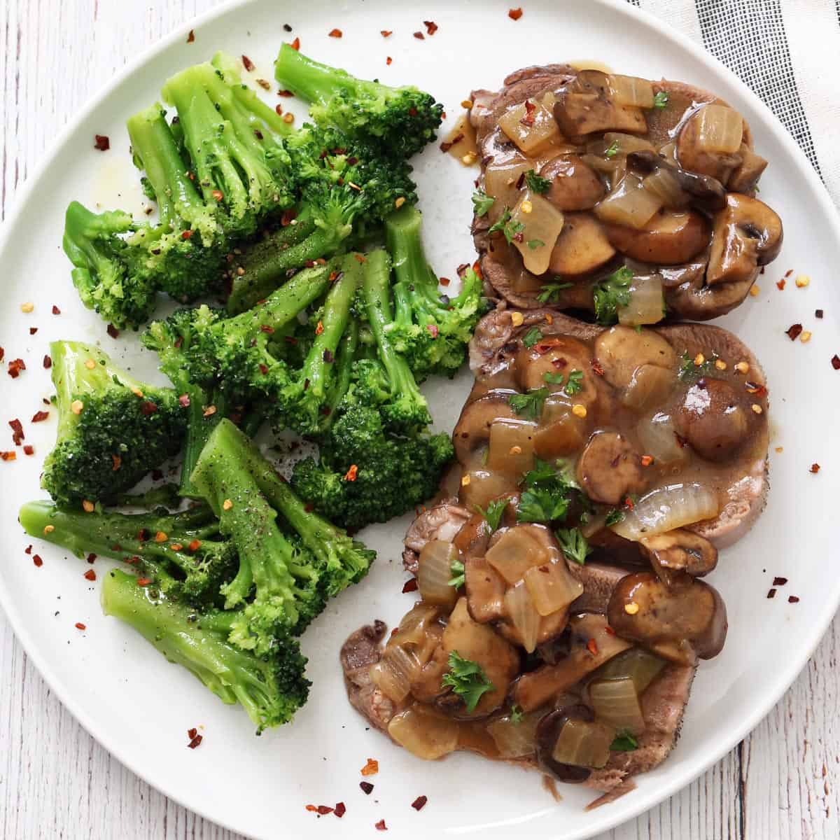 Beef tongue is served with broccoli.