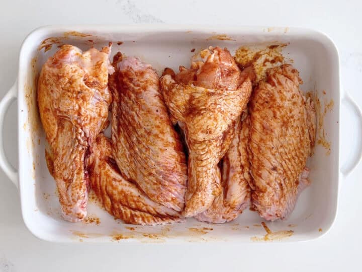 The wings are in the pan, coated in the seasoning mix.