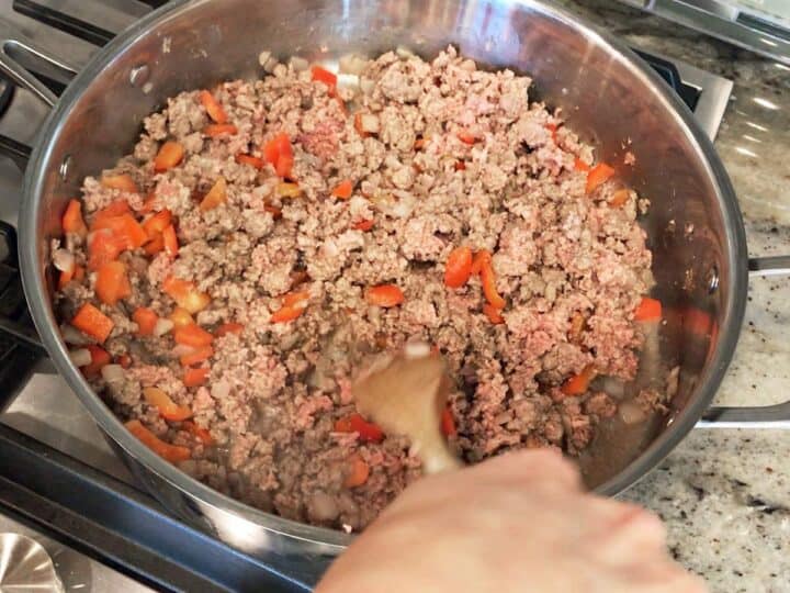 Cooking ground beef, onions, and bell peppers.