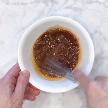 Mixing the sauce in a bowl.