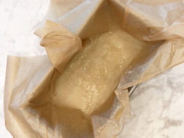 A loaf pan with a parchment overhang.