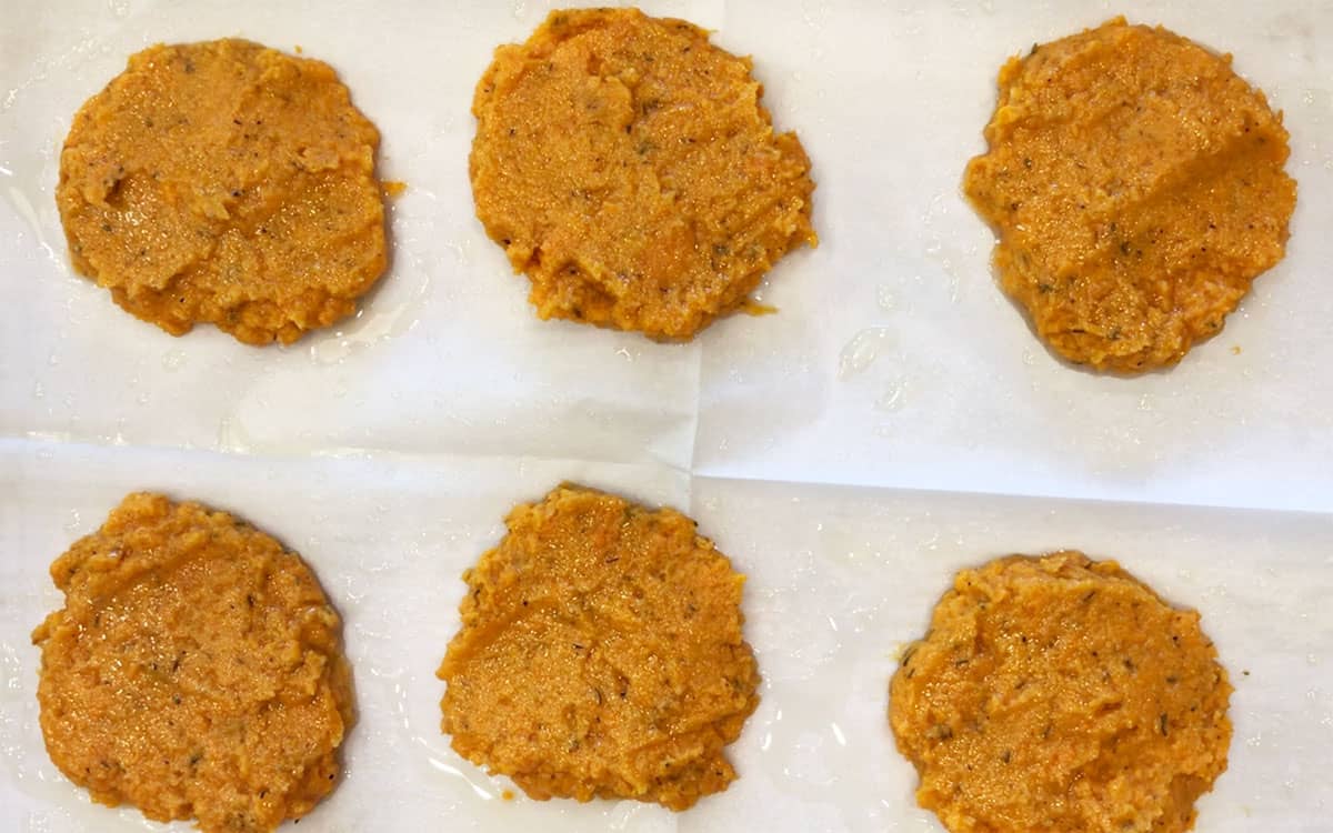The patties are on the baking sheet, ready for the oven.