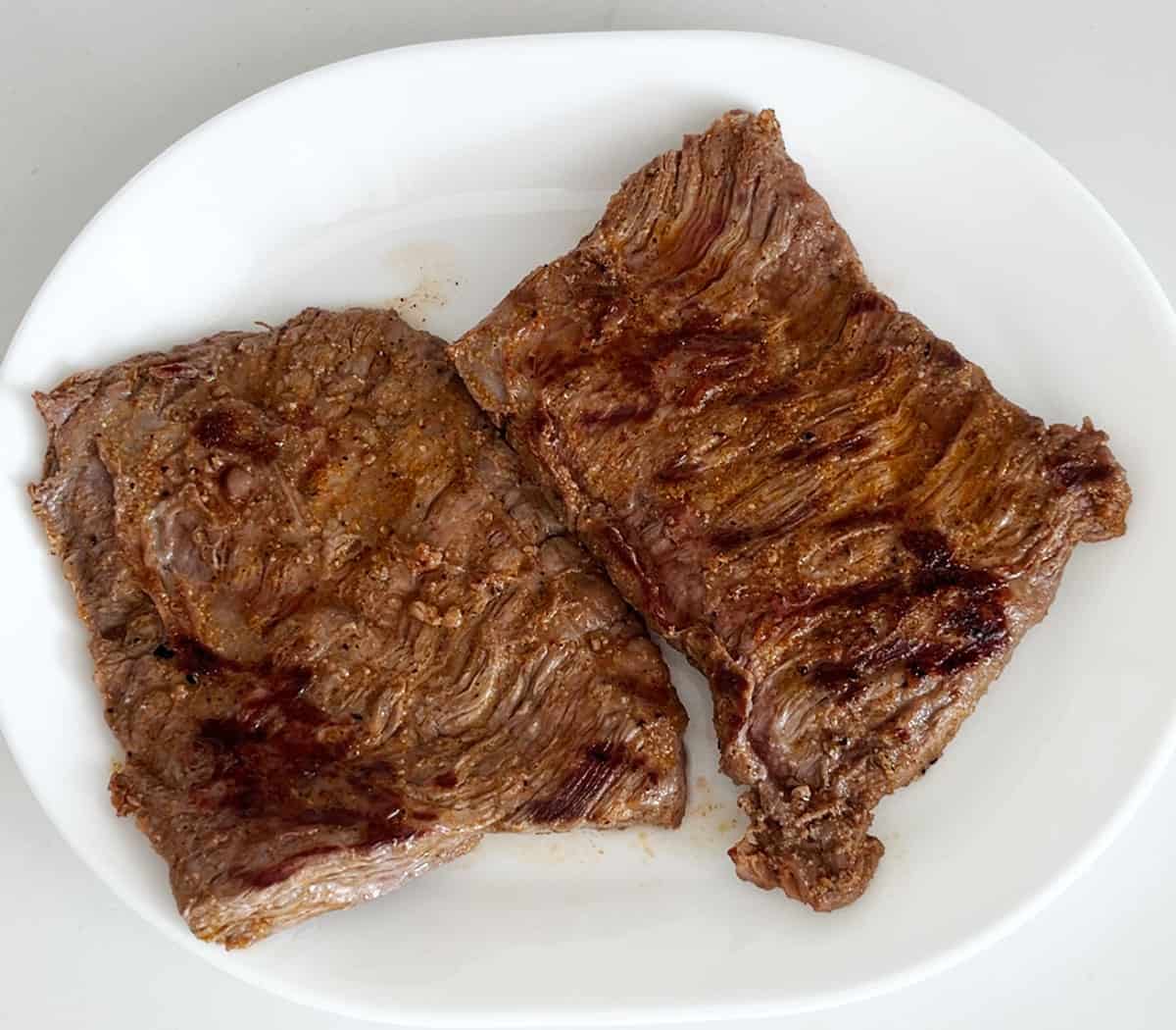 Resting the steak after grilling.