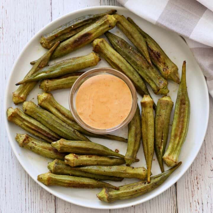 Roasted okra is served with a dipping sauce.
