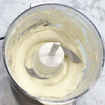 The whipped cream is ready in the food processor.