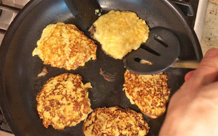 Flipping the fritters.