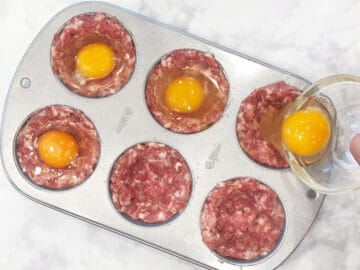 Adding the eggs to the muffin cups.