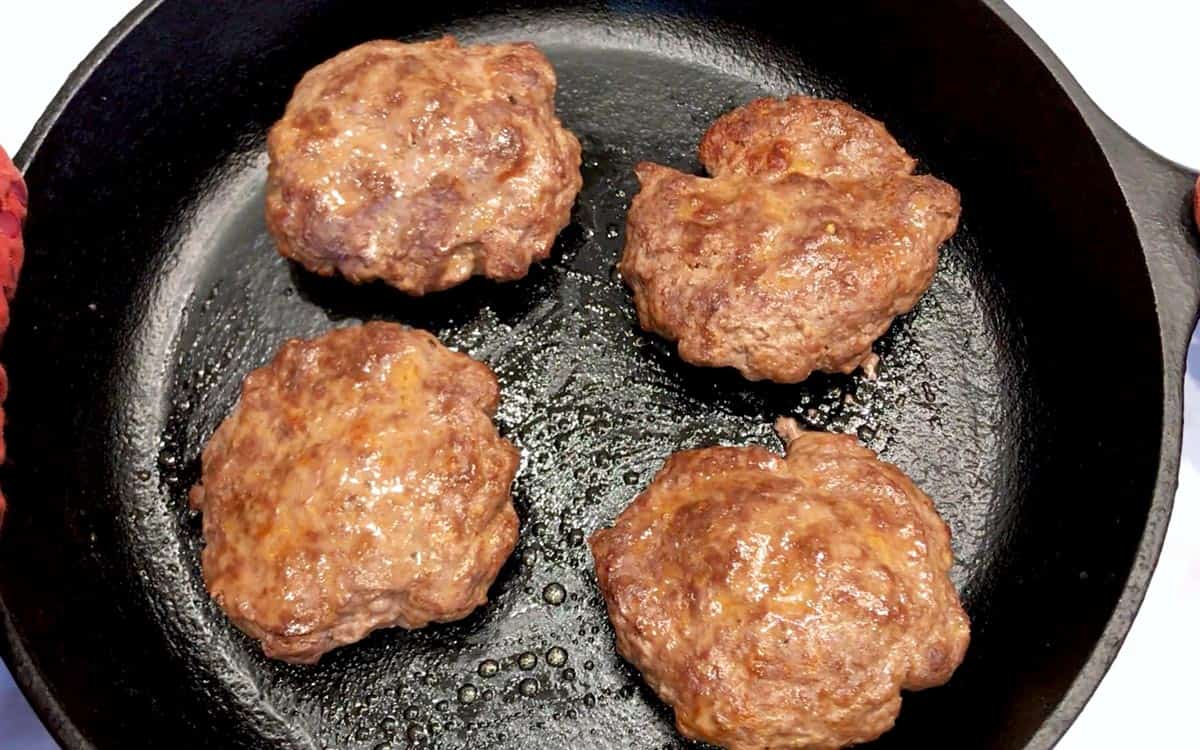 The burgers are ready in the skillet.