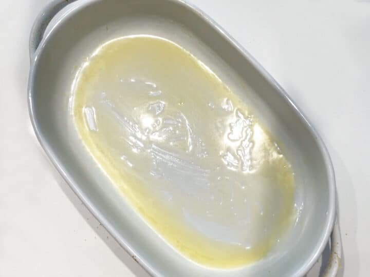 A buttered oval baking dish.