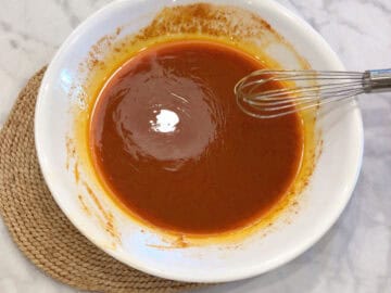 Mixing buffalo sauce in a bowl.