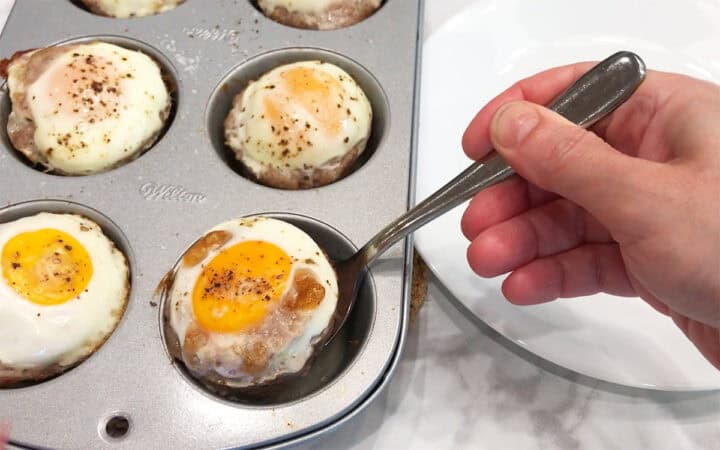 Removing the muffins from the pan.