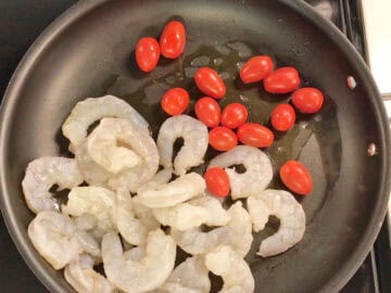Shrimp and tomatoes were added to the skillet.
