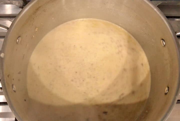 Bringing the soup to a simmer.