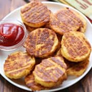 Cauliflower bites are served with ketchup for dipping.