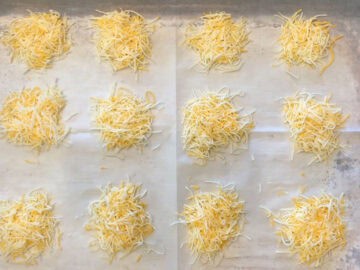 Cheese mounds on a baking sheet.