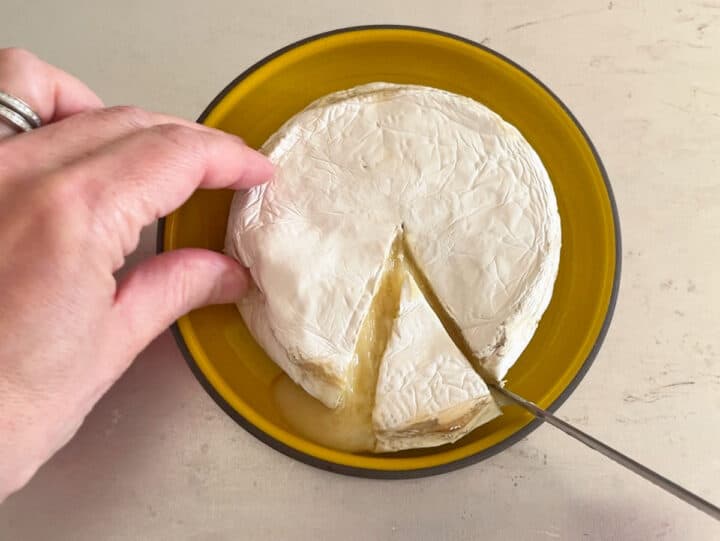 Cutting the baked cheese.