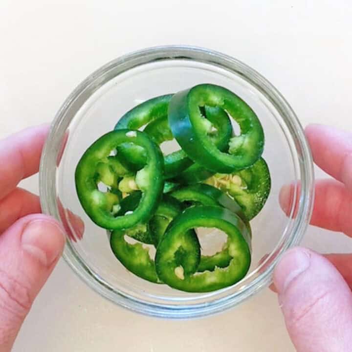 Jalapeno slices in a small bowl.