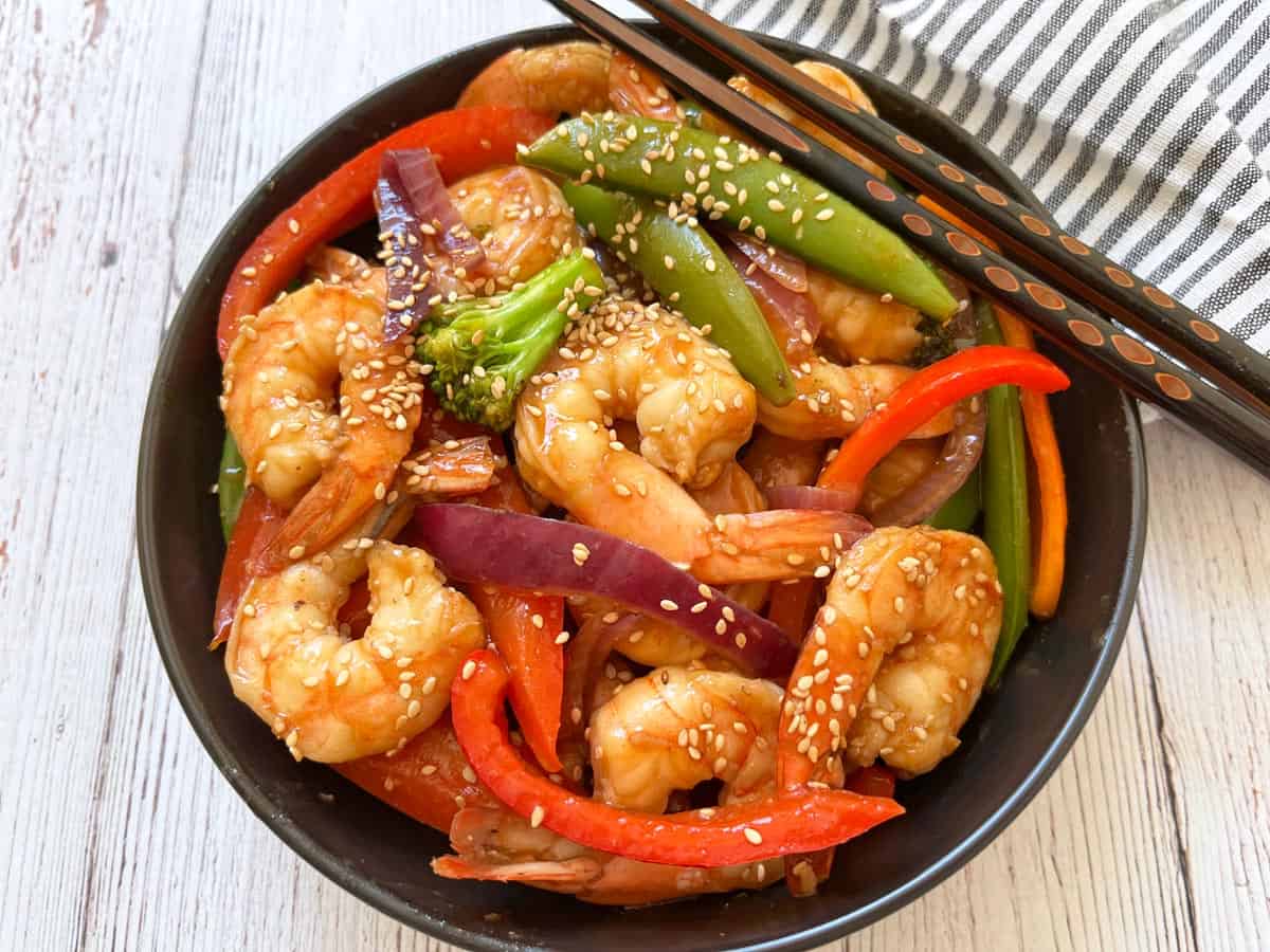 Shrimp stir fry is served in a bowl.