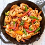 Shrimp stir fry is served in a skillet.