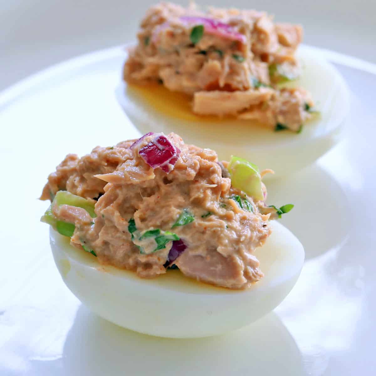 Hard-boiled eggs are topped with tuna salad.