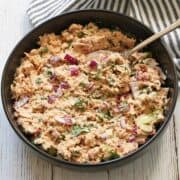 Spicy tuna salad is served in a bowl with a spoon.