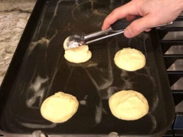 Adding the pancakes to the griddle.