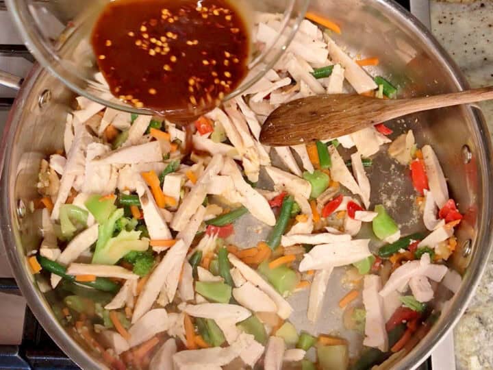 Adding the turkey and sauce to the skillet.