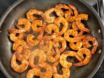 Cooking the shrimp in the skillet.