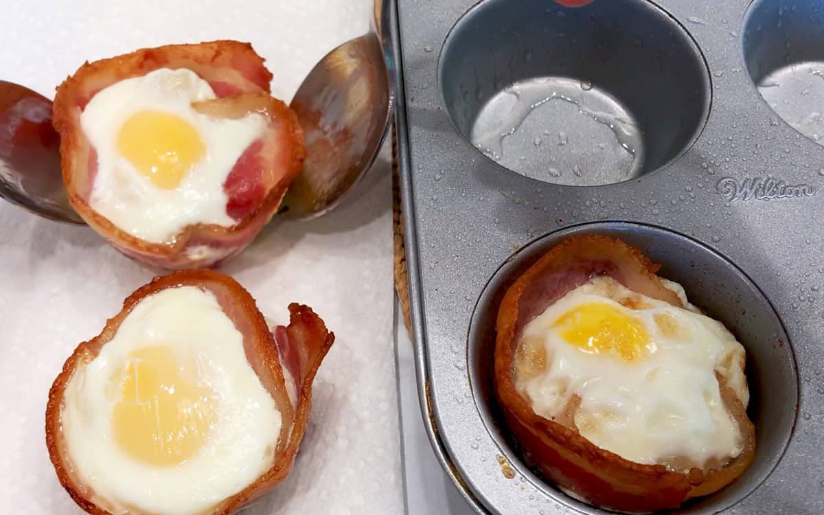 Removing the baked cups from the pan.