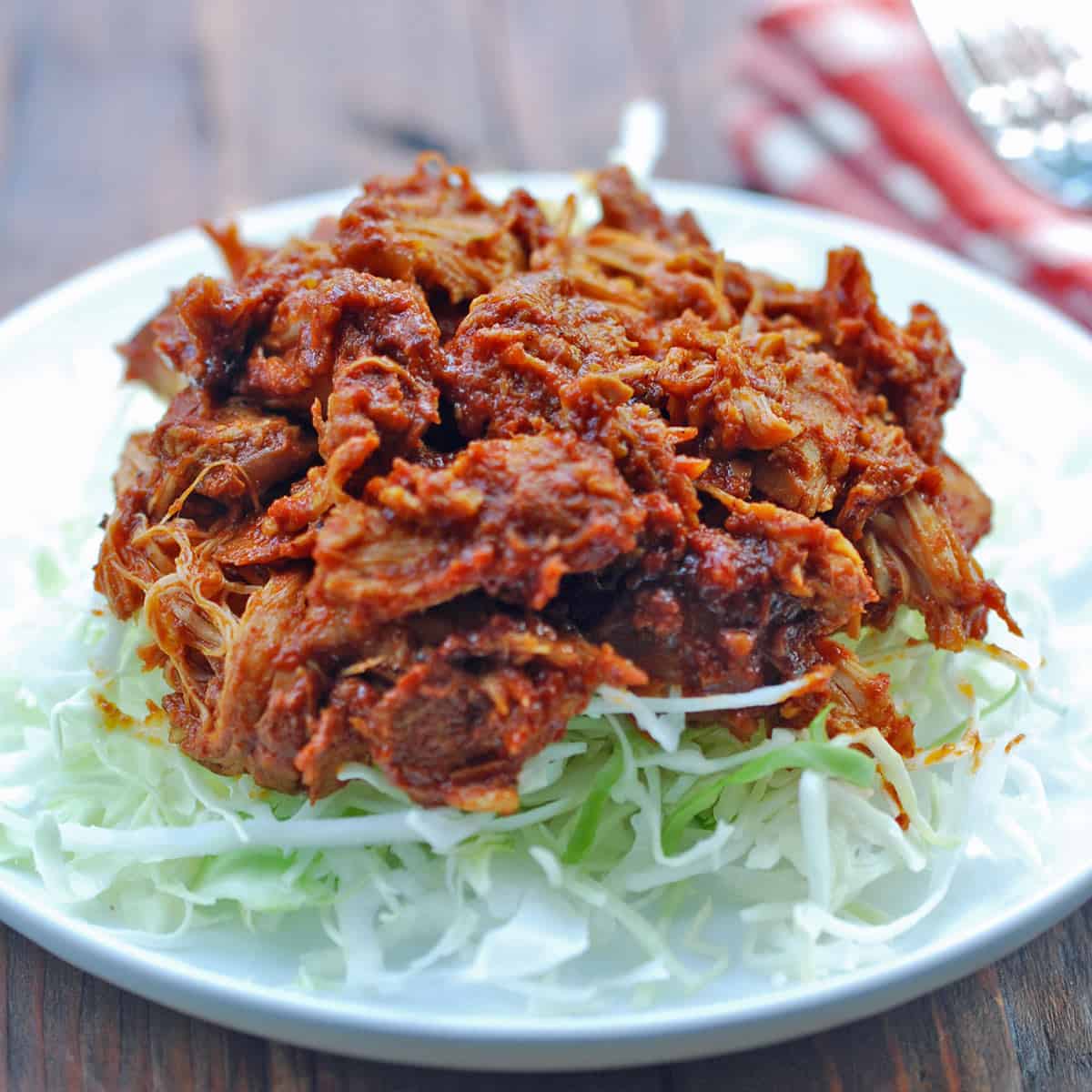 The pork is served on shredded lettuce.
