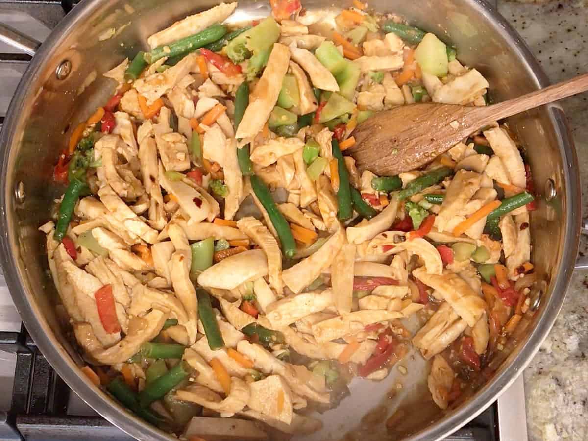 The stir fry is ready in the skillet.