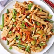 Turkey stir fry is served on a white plate.