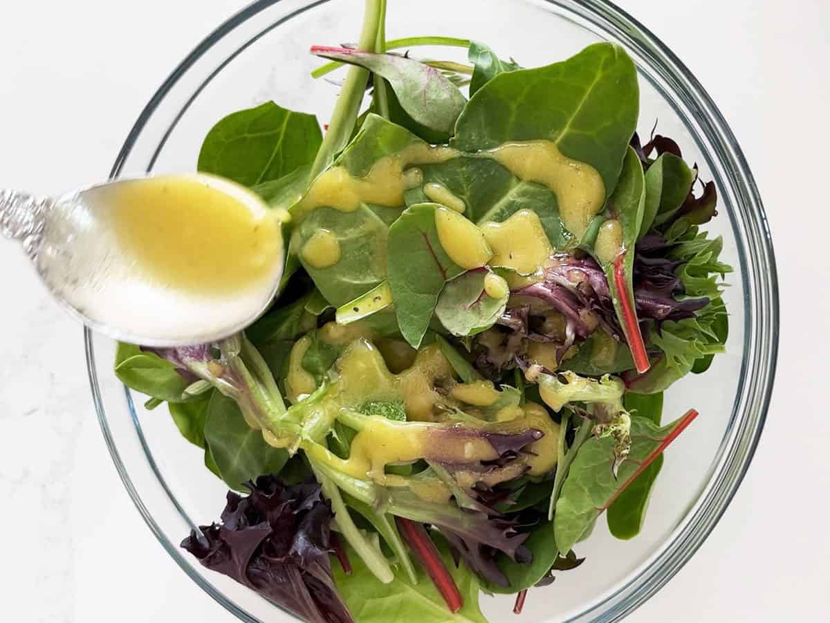 Using the vinaigrette on mixed salad greens.