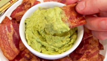 Dipping a bacon chip in guacamole.